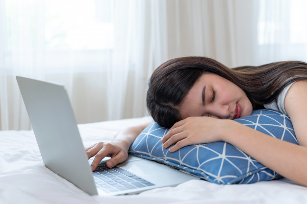 young-beautiful-woman-fell-asleep-bed-after-fatigue-from-working-with-laptop-computer_1150-15446